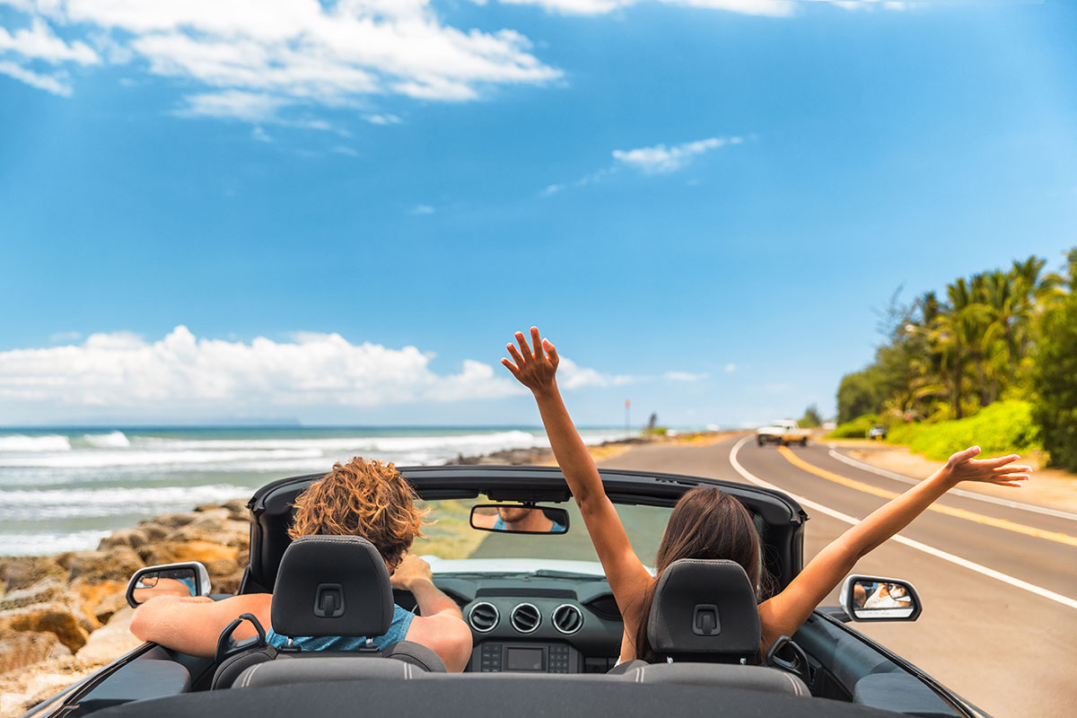 Couple enjoying scenic view in chauffeur-driven car during outstation trip - Best choice for long-distance travel.